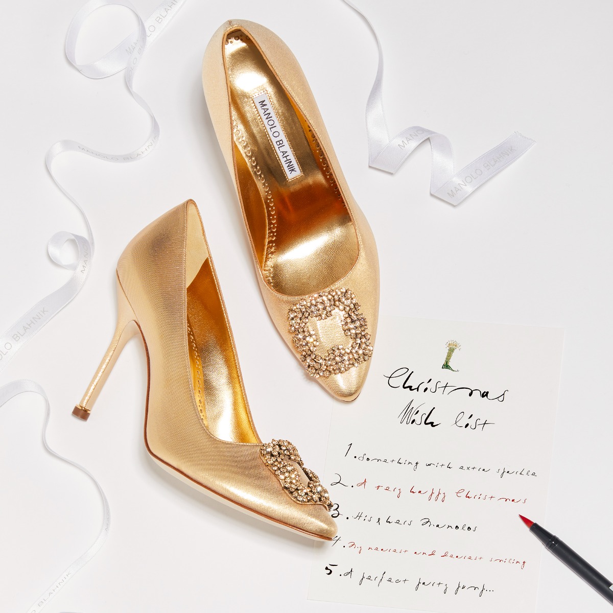 A Christmas wish list laying next to the gold collection Hangisi pumps.