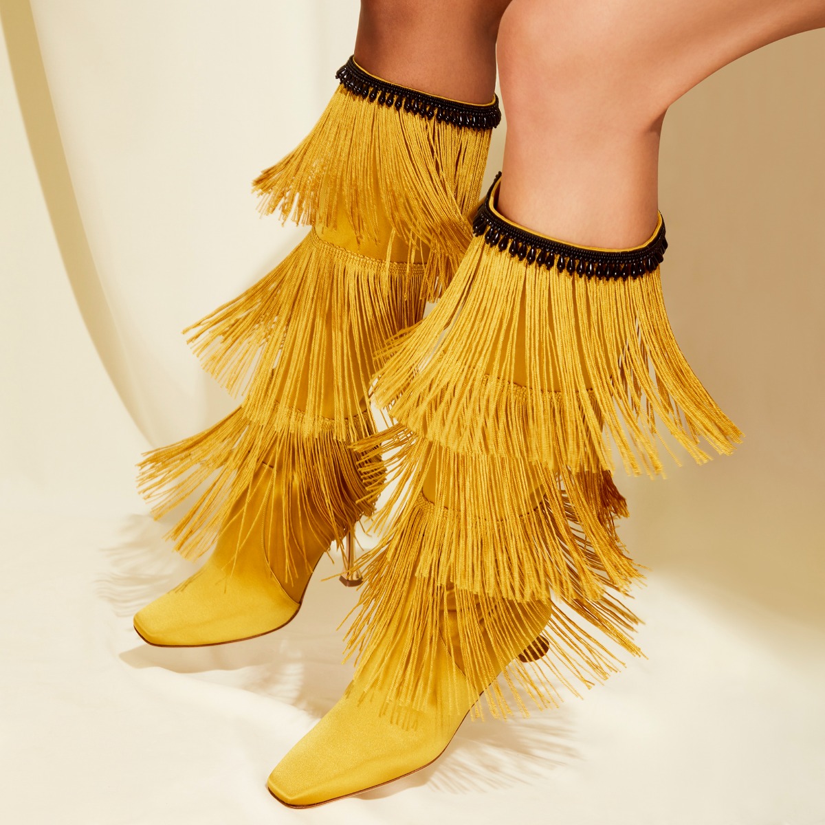 Editorial image of the FLEQUILLOHI boot with two models showcasing the beautiful fringe detailing.