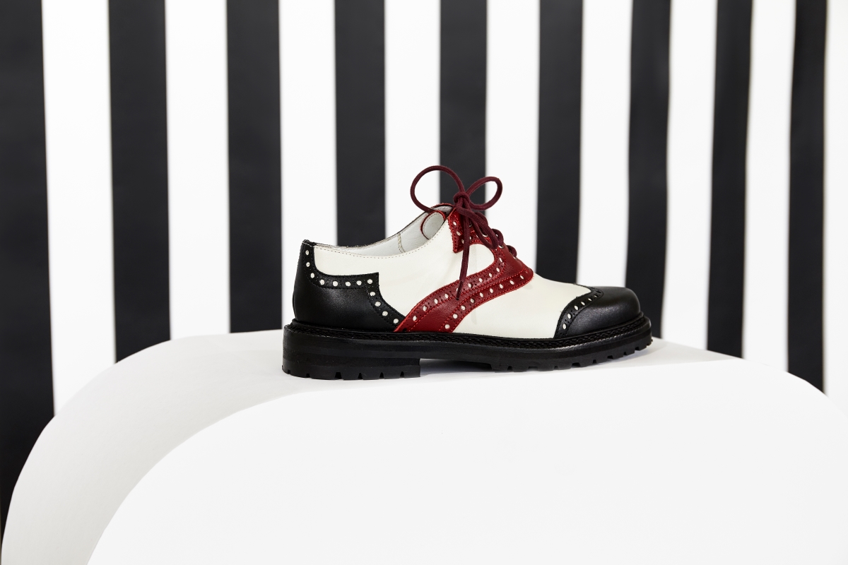 Editorial image of the Patrola brogue against a monochromatic striped background.
