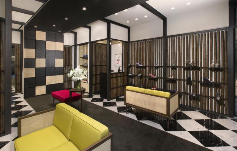 The Marina Bay Sands, Singapore store. The walls have bamboo on them there are shoe shelves attached to the bamboo.