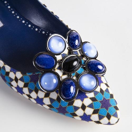 A blue geometric print shoe with enamel buckle