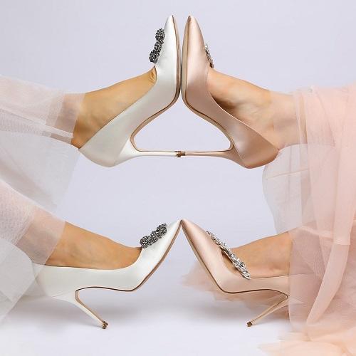 toe to toe wearing white satin and champagne satin pumps