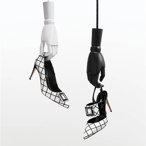 Wooden dolls holding black and white windowpane pumps and black and white windowpane pumps with crystal embellishment.
