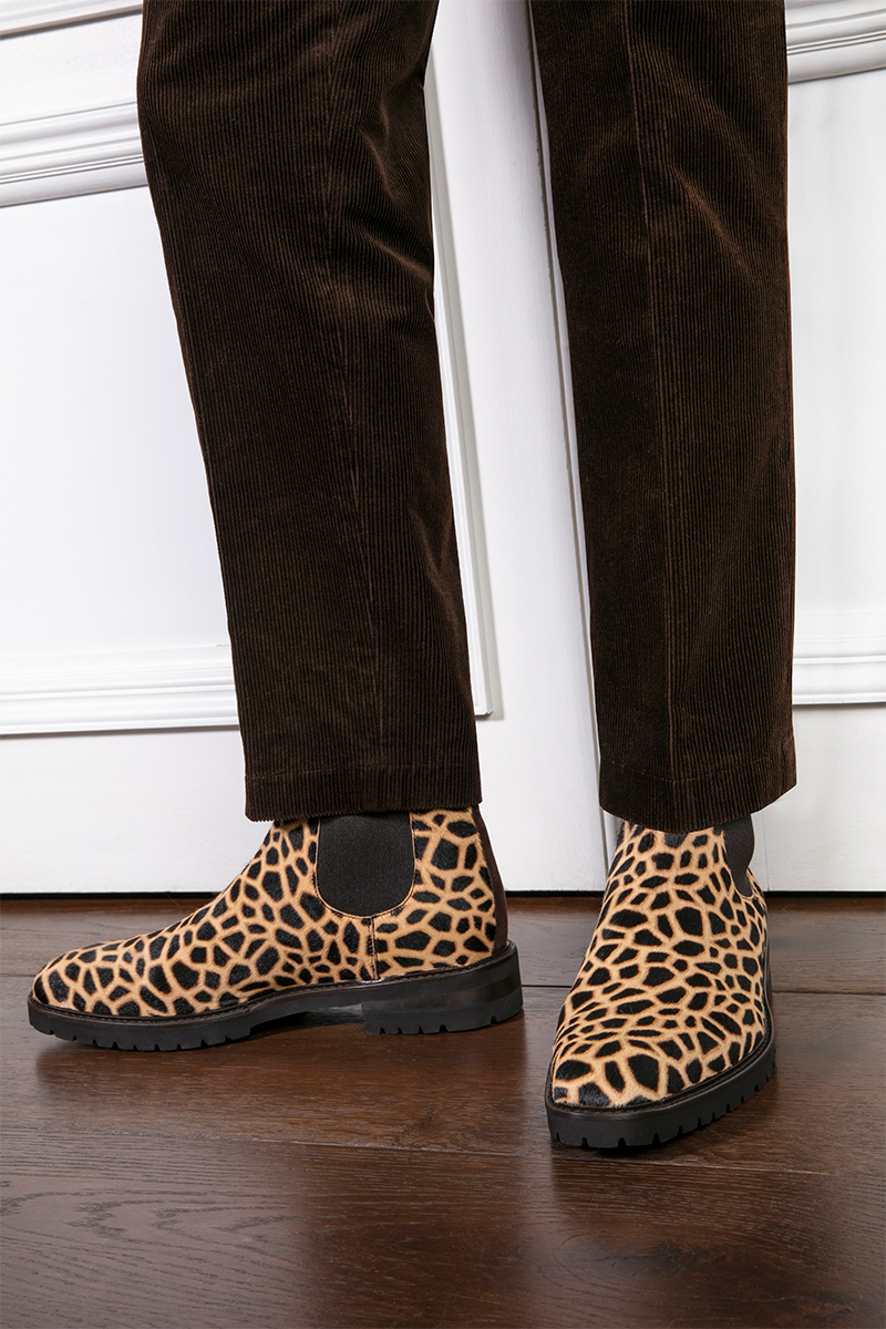 Model wearing giraffe print calf hair ankle boots 