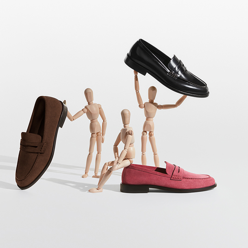 Wooden dolls with pink penny loafers with black sole, brown penny loafers with black sole and black patent loafers