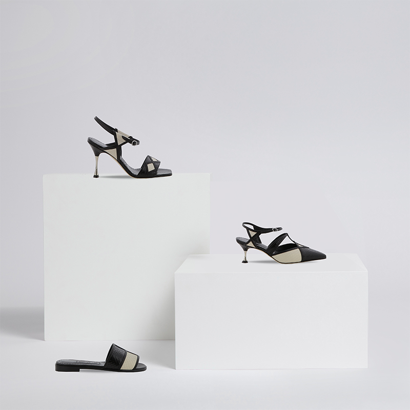 Image displaying the Rudi Gernreich story, featuring an array of pumps and sandals in monochrome water snake.